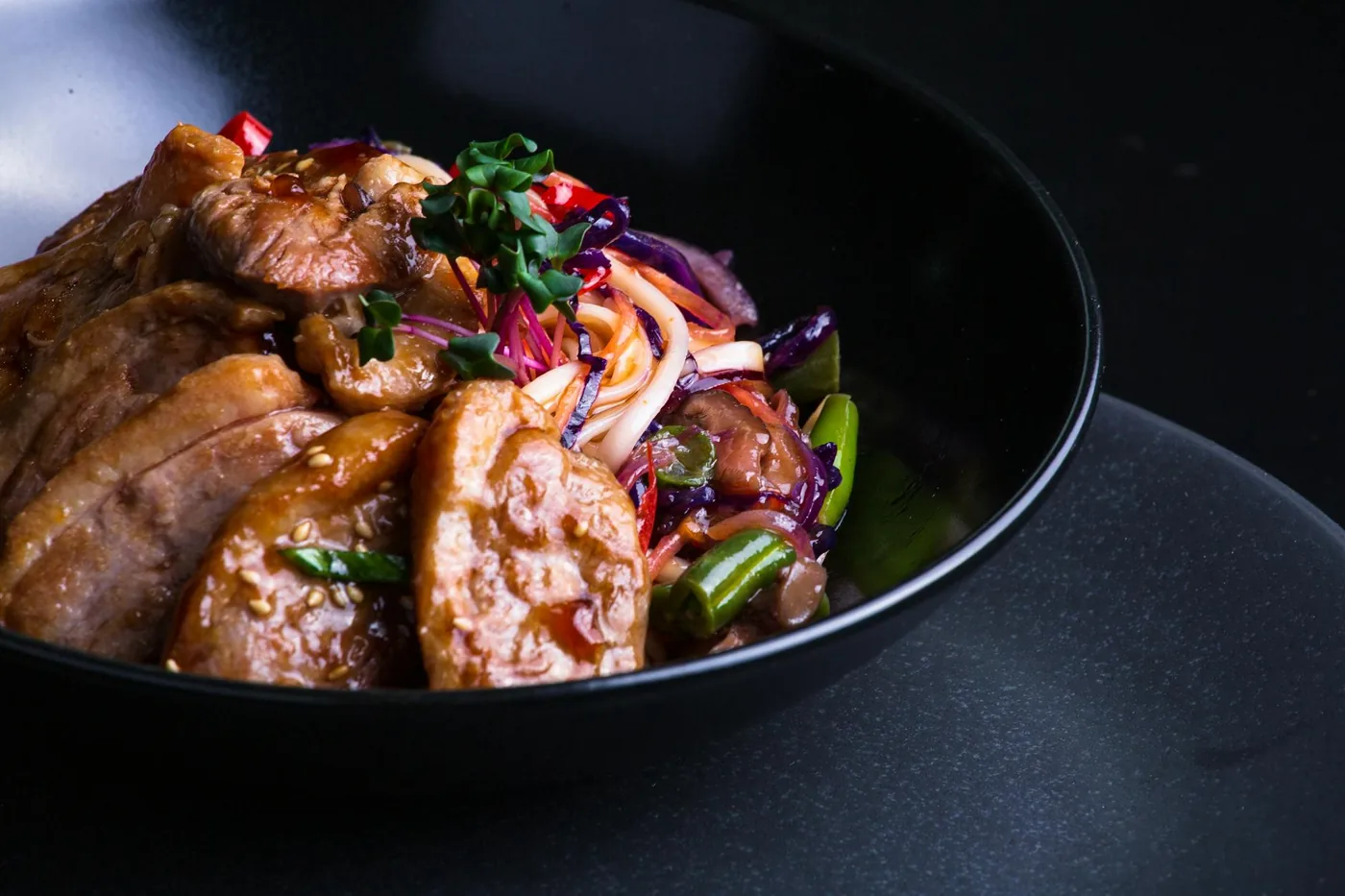 Vegetable stir-fry in a pan with a glossy savory sauce.